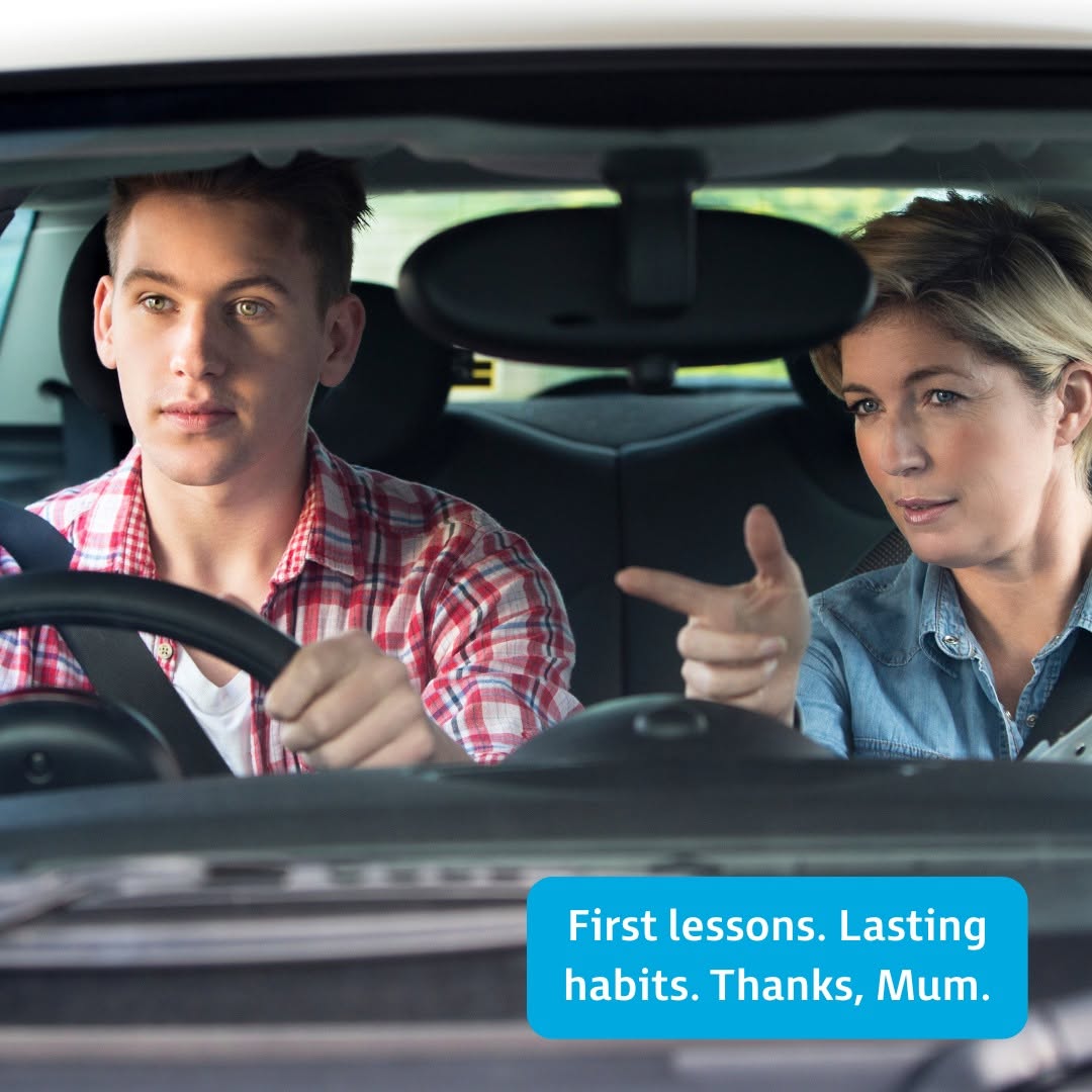 Mother pointing and giving driving advice to teenage son practicing behind the wheel, before starting lessons with Drive Solo Driving School in Perth WA