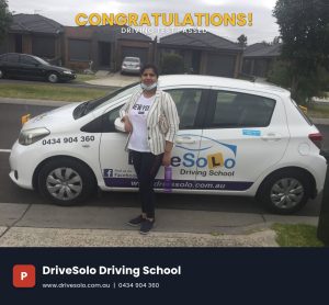 Female driving student celebrating passing her driving test with DriveSolo Driving School instructor car in Rockingham
